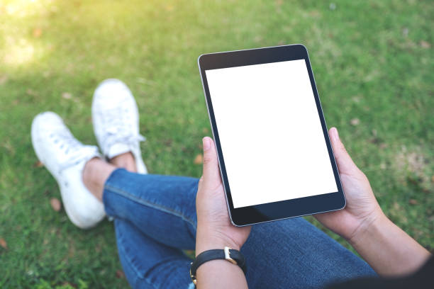 istock a woman holding and using black tablet pc with blank white desktop screen 1127448272