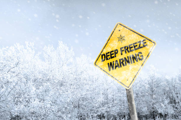 istock Winter Freezing Weather Warning Sign With Snowfall Background 1127448492
