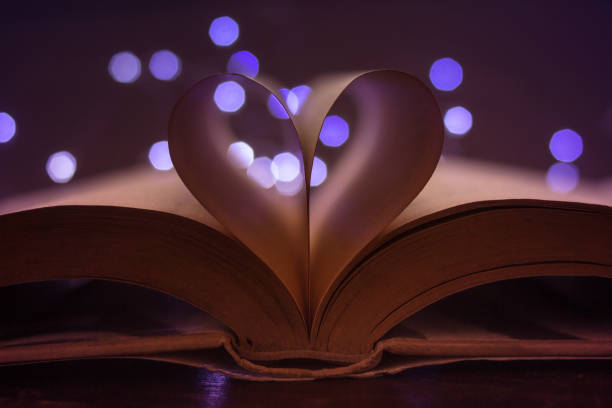 istock book pages forming a heart and lights at background - reflection 1127450113