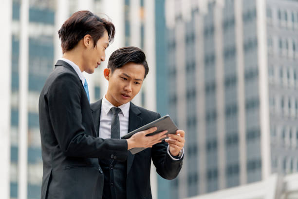 istock Two young businessmen having a meeting on the go 1127450231