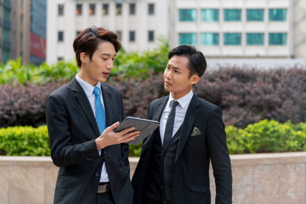 istock Two young businessmen having a meeting on the go 1127450240