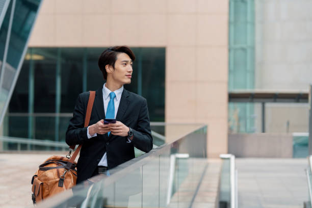 istock Young businessman using his phone outdoors 1127450241