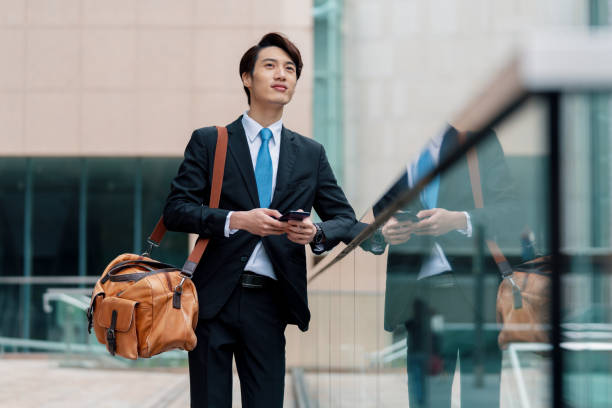istock Young businessman using his phone outdoors 1127450247