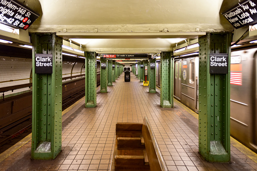 BROOKLYN, NEW YORK - MARCH 8, 2015: MTA Clark Street Subway Station (2, 3) in the Brooklyn Heights area of Brooklyn, New York with an arriving train.
