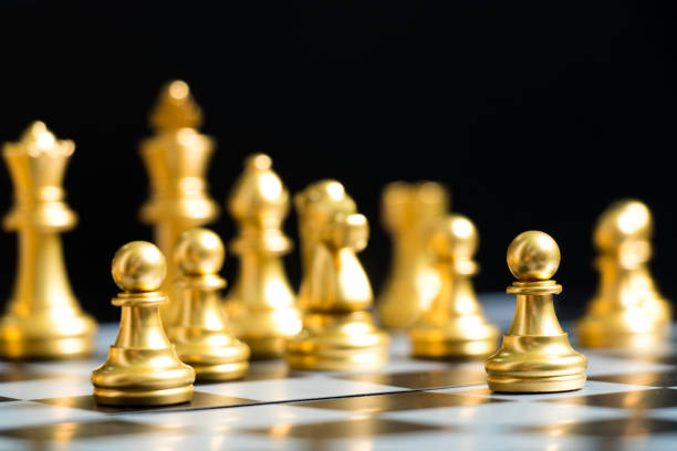 istock Gold chess piece move in game on black background (Concept for business decision, company strategy) 1127452133
