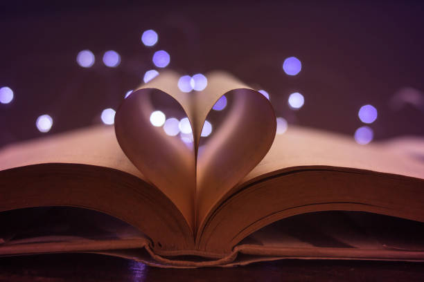 istock book pages forming a heart and lights at background 1127452359