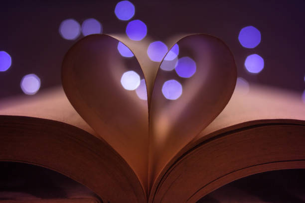 istock book pages forming a heart and lights at background - bokeh blur 1127453000