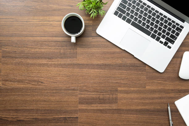 istock Wood office desk table with laptop computer, smartphone and supplies. Top view with copy space, flat lay. 1127454129