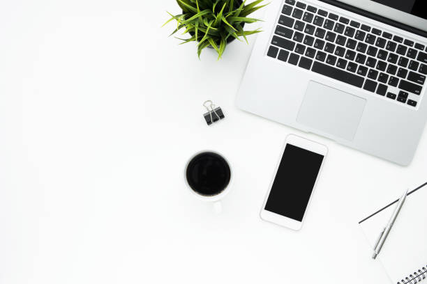 istock White office desk table with smartphone, laptop computer and supplies. Top view with copy space, flat lay. 1127454333