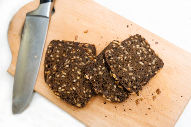 istock Rye bread with seeds is cut into pieces on a cutting board. 1127455702