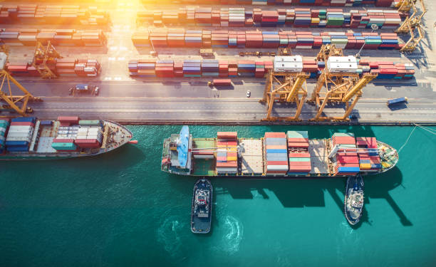 istock Logistics and transportation of Container Cargo ship and Cargo plane with working crane bridge in shipyard at sunrise, logistic import export and transport industry background 1127456802