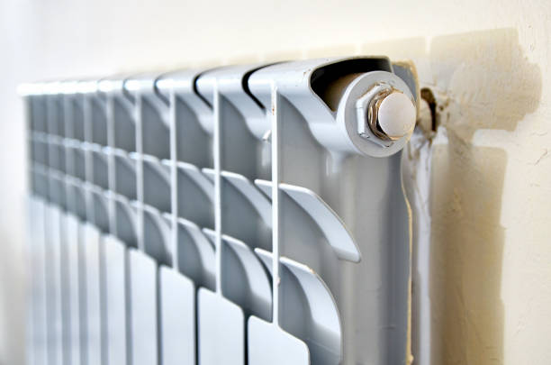 istock Heating Radiator. White radiator in an apartment. 1127457608