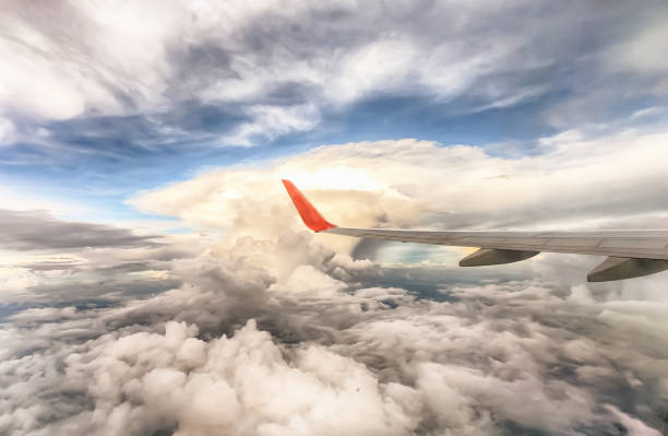istock View from the plane window, see the dramatic clouds and the vast sky. 1127463772