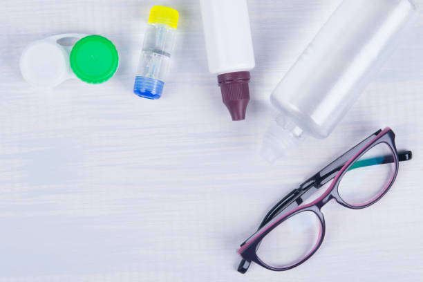 istock container for cleaning lenses, to improve vision and glasses, on a light background 1127464420