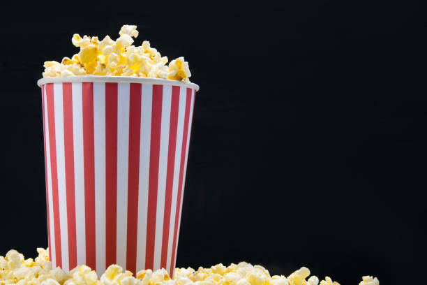 istock on a black background, a bucket of popcorn, with space for writing 1127464607