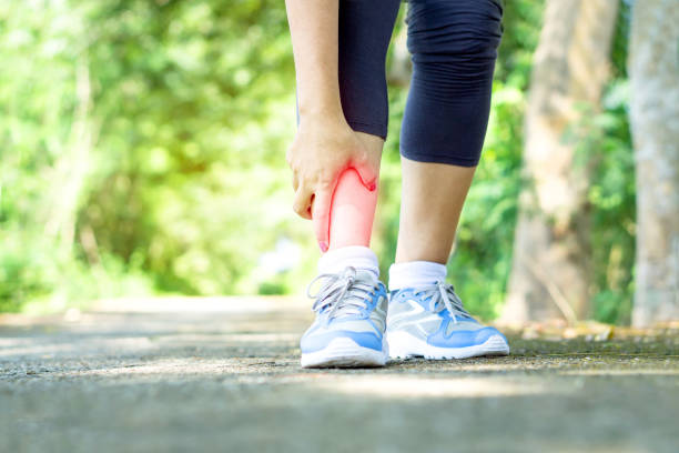 istock woman hand touching her leg pain twisted ankle broken 1127466711