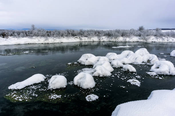 istock Winter landscape by a river in the sunset 1127469563
