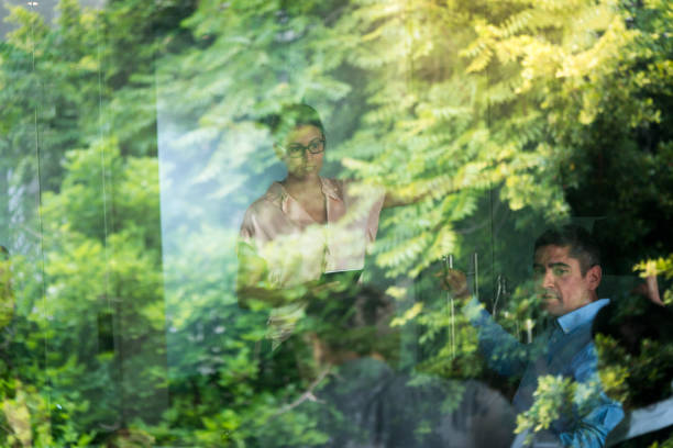 istock Business people seen through glass window 1127471282