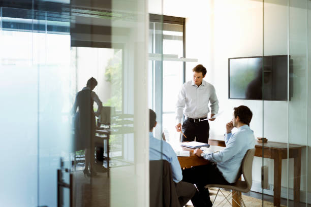 istock Businessman discussing with colleagues in office 1127471624