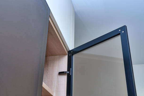 istock Luxury wardrobe with glass framed doors. Wooden wardrobe close-up 1127472771
