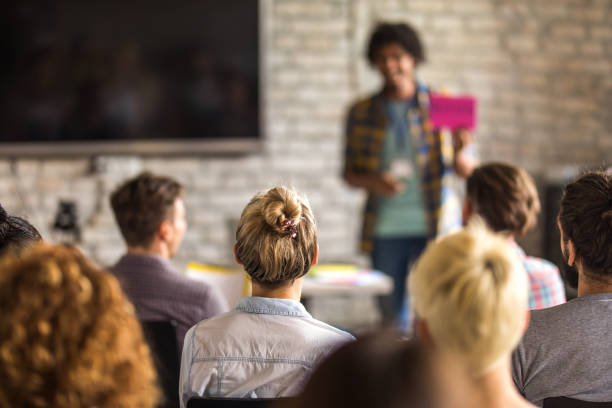 istock Rear view of creative people attending an education event. 1127472817