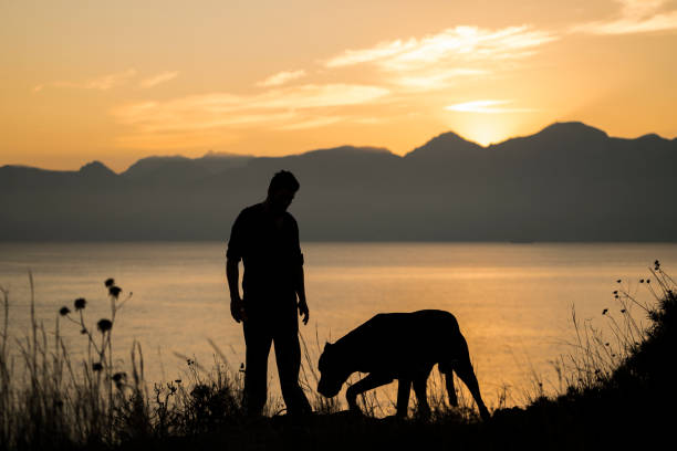 Man with his dog at sunset, Antalya Turkey