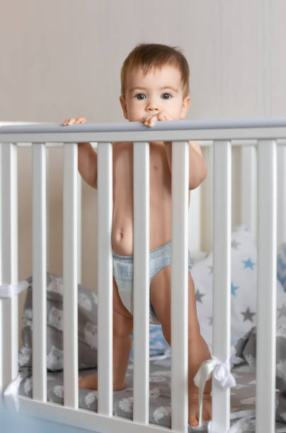 istock baby boy standing in crib 1127475960