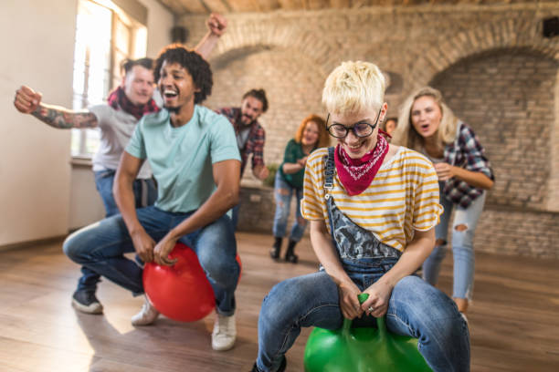 istock Cheerful colleagues having fun during space hopper at casual office. 1127476233