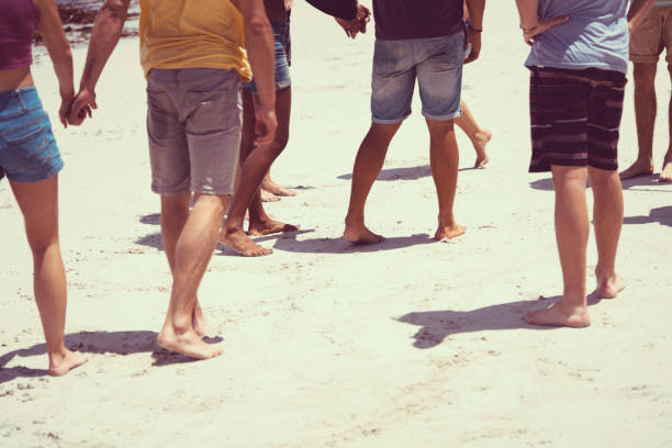 istock Multi-ethnic friends walking at beach during summer 1127477153