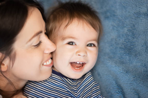 istock mother and baby boy on bed 1127477598