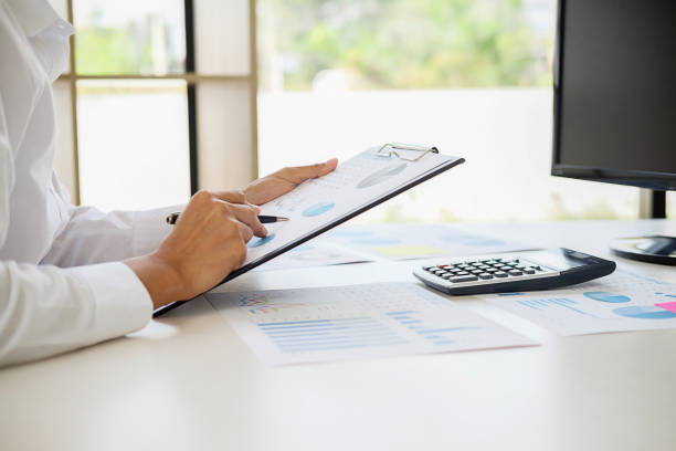 istock Business adviser analyzing financial figures denoting the progress Internal Revenue Service checking document. Audit concept 1127477703