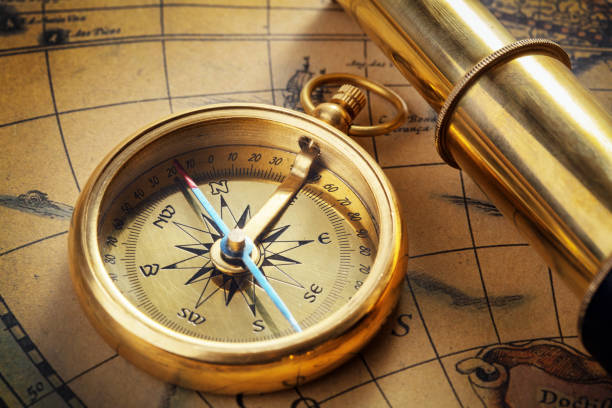 istock antique compass, magnifier, spyglass on map 1127479132