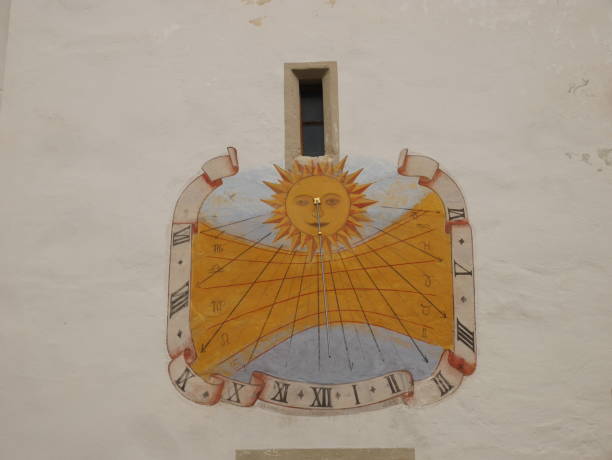 istock Painted Sundial on White Church Wall in Austria 1127479943