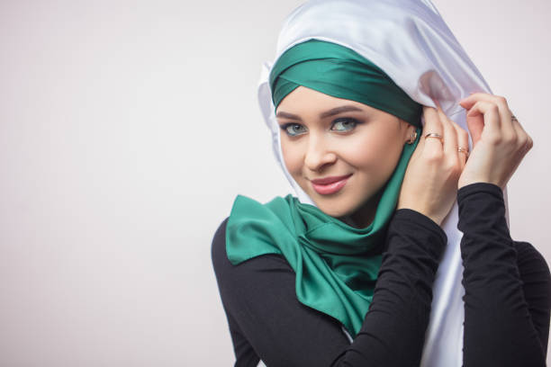 close up portrait od beautiful Muslim girl showing how to tie a headscarf close up portrait od beautiful Muslim girl showing how to tie a headscarf. master class. workshop arabian girl stock pictures, royalty-free photos & images