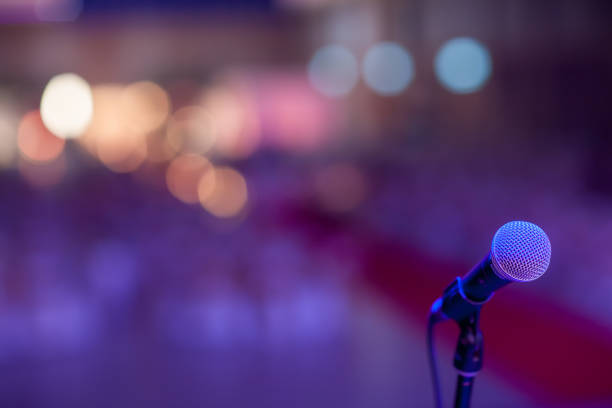 istock microphone in concert hall or conference room soft and blur style for background. 1127481781
