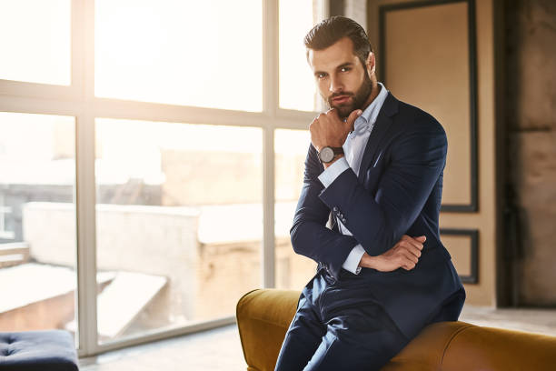 istock Developing a new idea...Handsome and successful businessman in stylish suit is thinking about something while standing at office 1127483229