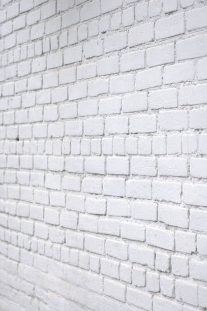 istock A brick wall painted in blue is removed from the side view. 1127483632