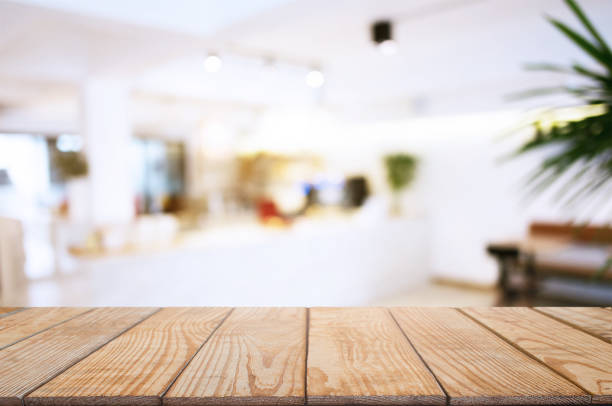 istock wooden table with blurred montage coffee shop cafe background 1127484422