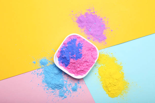 istock Holi powders in bowl on colorful background 1127484772