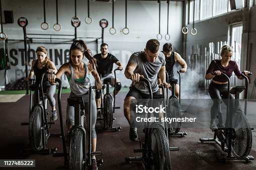 istock gym training on stationary bikes! 1127485222
