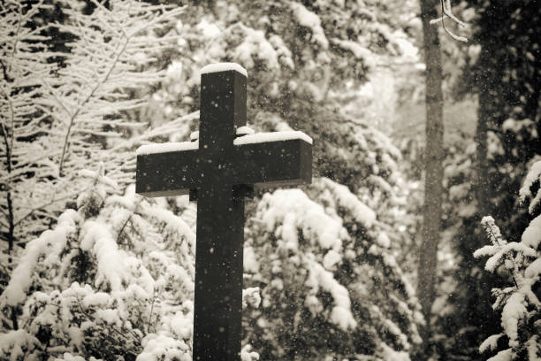 Weathered old stone cross on the Melaten Graveyard, Cologne, Germany
