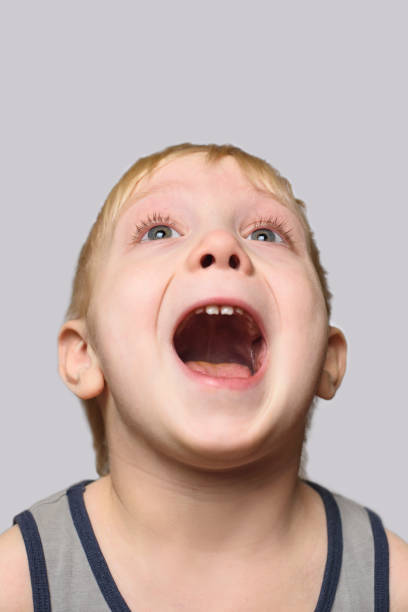 istock Joyful blond boy in shirt with an open mouth. Isolate on white background. 1127486320