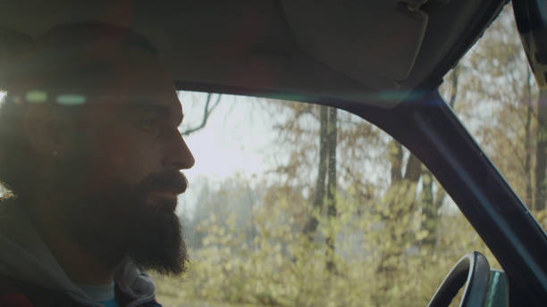 istock Young couple sitting in car. Passenger's POV 1127486560