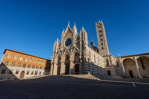 Siena Cathedral, Santa Maria Assunta 1220-1370 with clear blue sky. Tuscany, Italy, Europe