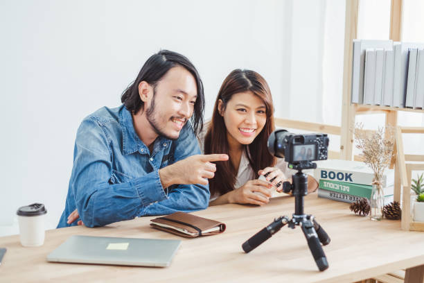 istock Two of young Asian blogger or vlogger using video online live streaming and broadcasting 1127489139