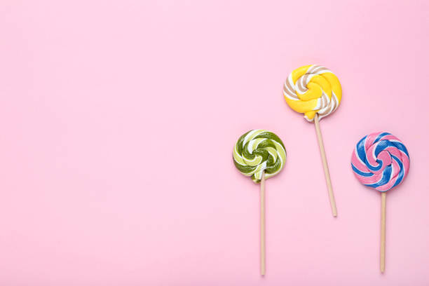 istock Colorful lollipops on pink background 1127489360