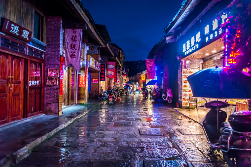 Street at night in the traditional Xingping village with neon lights, Guilin region, Guangxi province, China