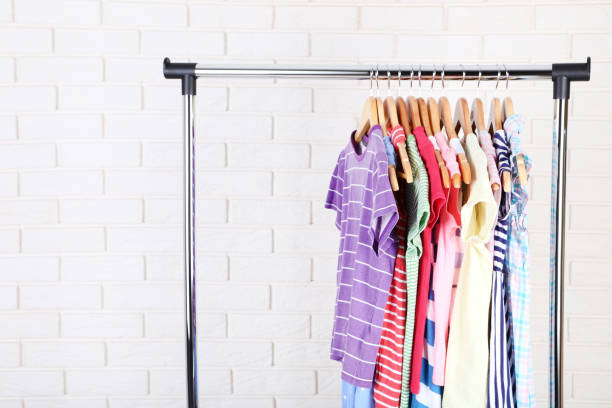istock Fashion clothes hanging on brick wall background 1127490423