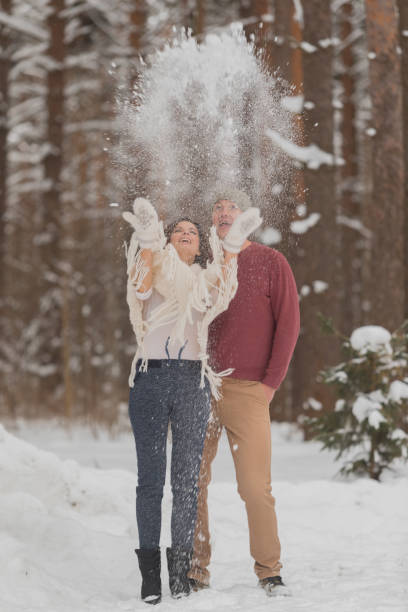 istock Young couple on a romantic walk in the winter forest 1127492416