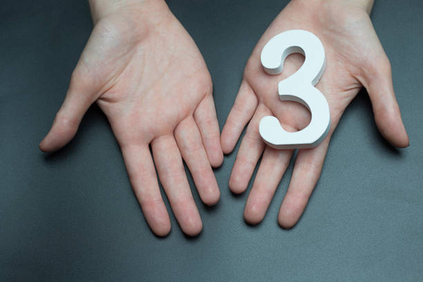 istock On the female palms figure three. 1127492563